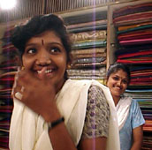 Sari saleswomen smiling.